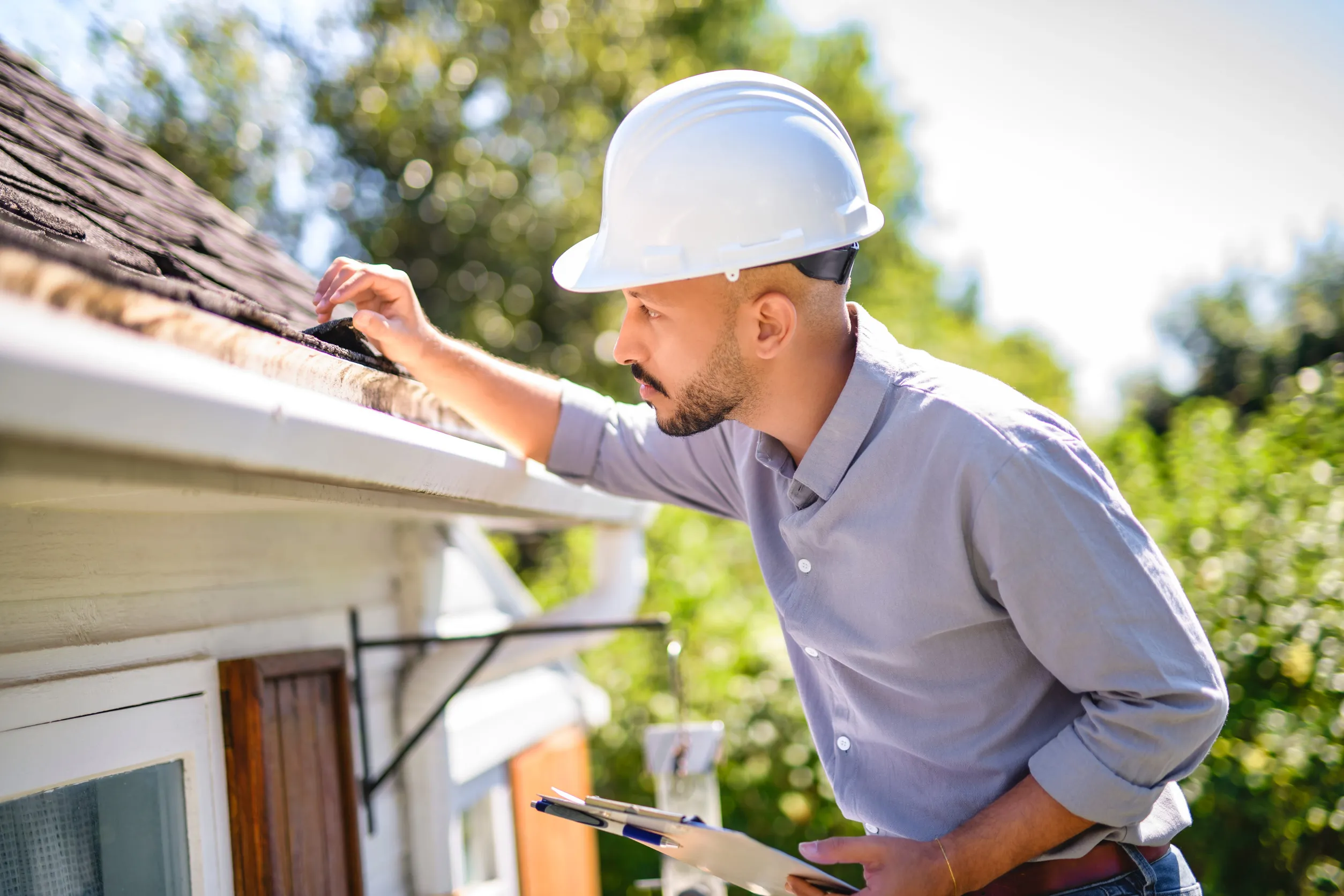 man with hard hat to roof inspector